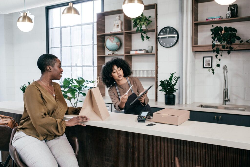 employee showing customer something on iPad